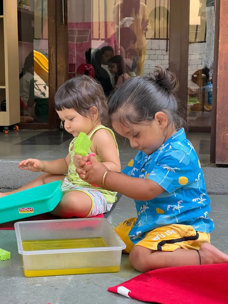 Toddlers exploring sensory water play